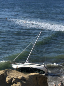 Sailboat grounded on Pacific Ocean Coast