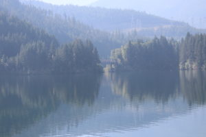 Beautiful lake, with it's reflections of trees and foothills creating a soothing image.